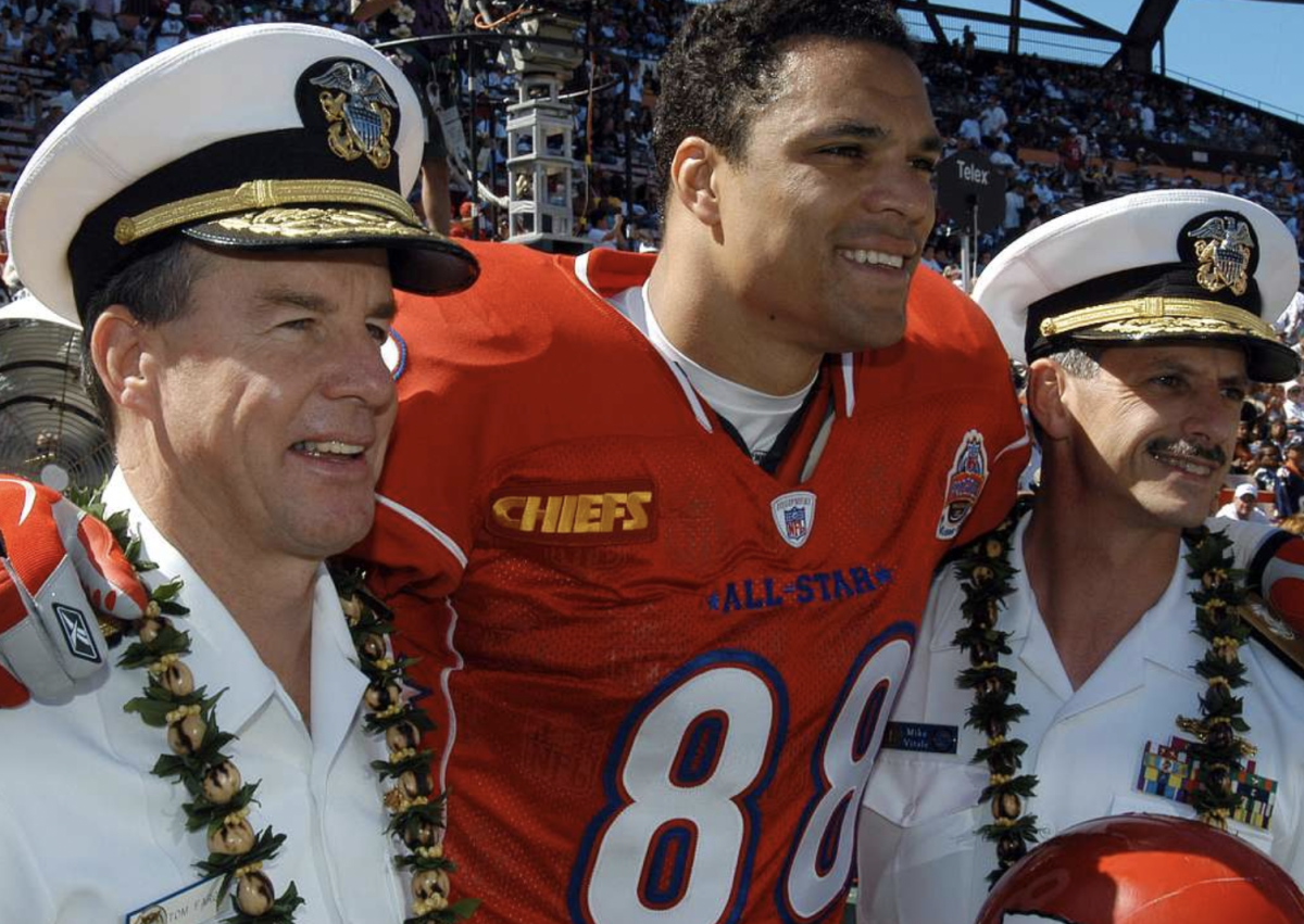 Commander Thomas Fargo and Commander Michael C. pose for a picture with Tony Gonzalez.